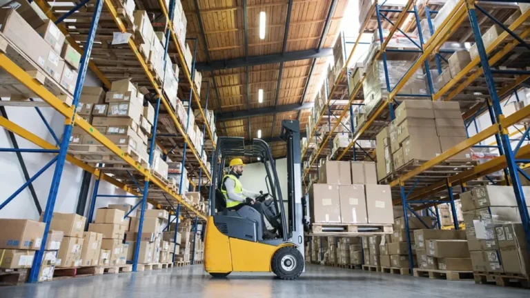 Forklift loading palletized LTL freight in a warehouse